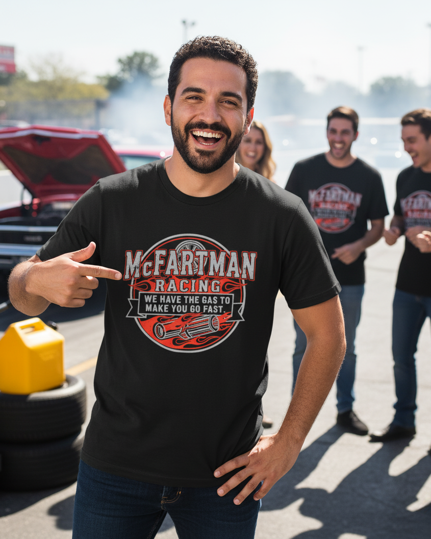 Man wearing a black t-shirt with 'McFarman Racing' design, standing in front of a group of people at a drag racing event.