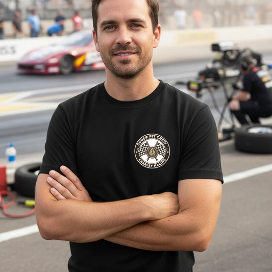 Man wearing a black t-shirt with a 'Sober Pit Crew Knarley Racing' logo on a race track