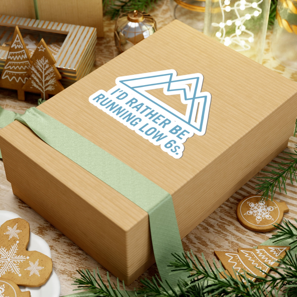 Wooden gift box with a sticker and winter-themed cookies on a festive background