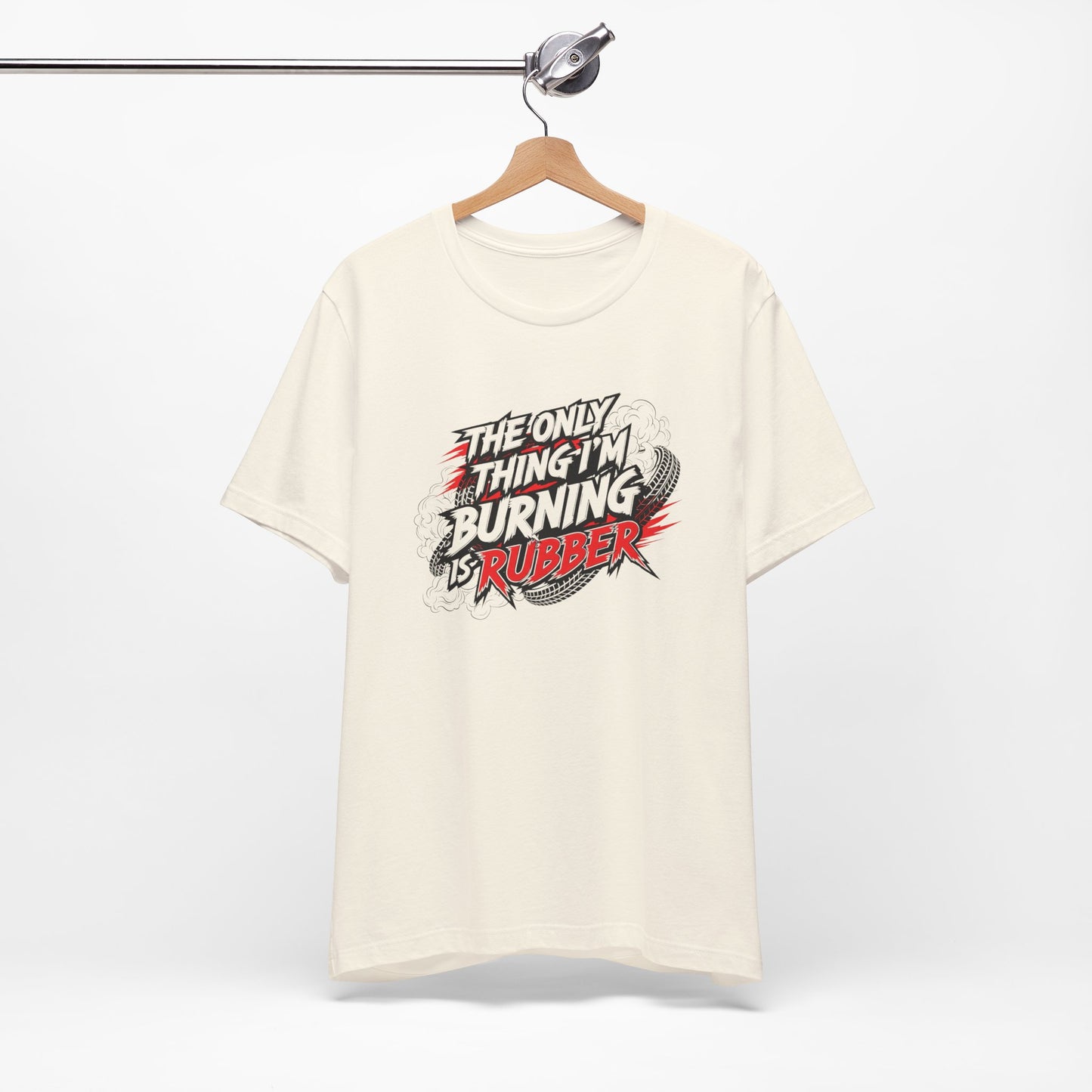 White t-shirt with graphic design and text 'The only thing I'm burning is rubber' on a hanger against a white background