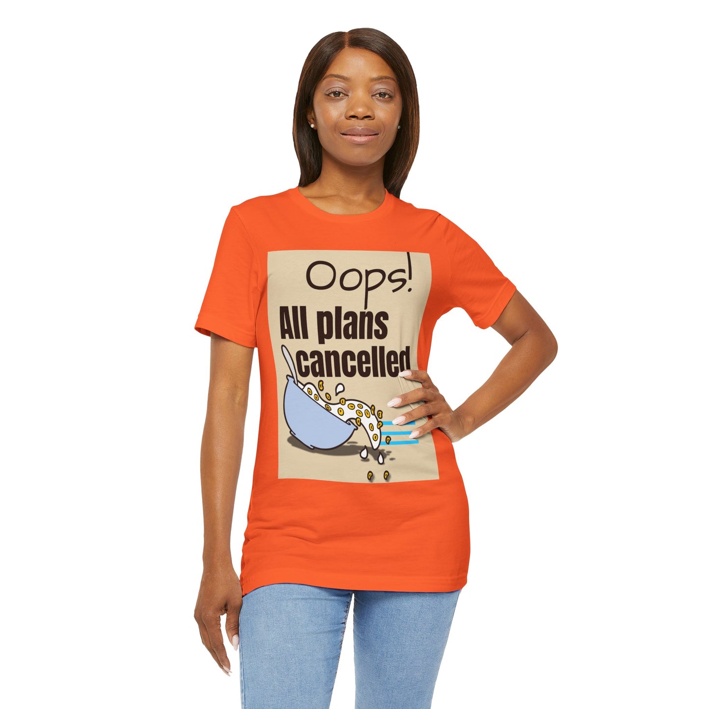 Woman wearing an orange t-shirt with a graphic and text 'Oops! All plans cancelled' on a white background
