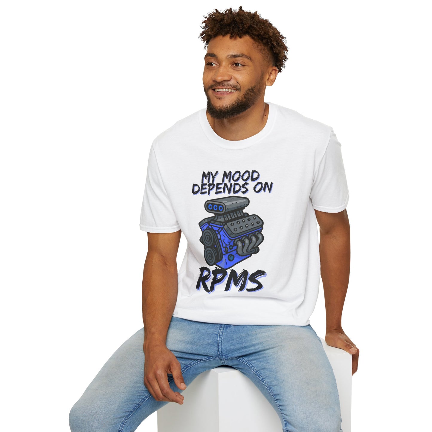 Man wearing a white t-shirt with a graphic and text, sitting on a white stool against a white background.