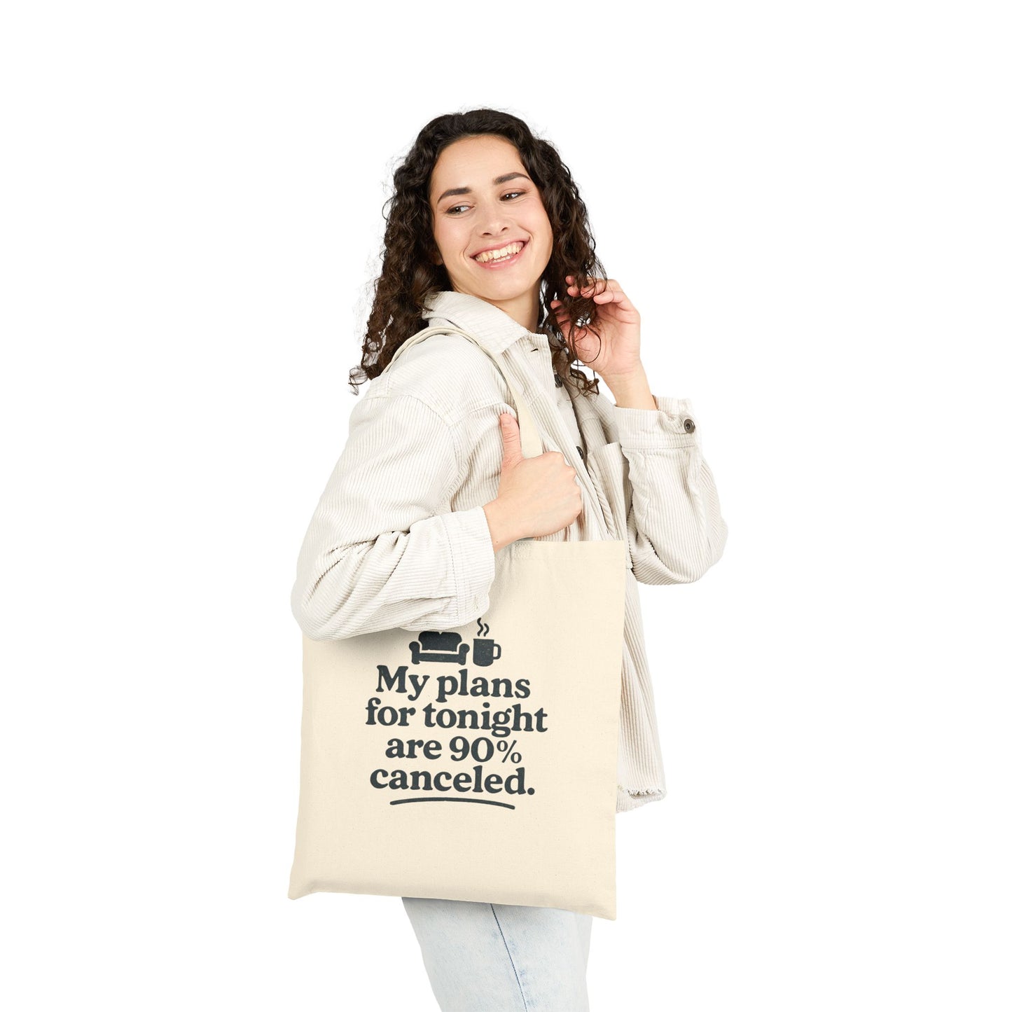 Woman holding a tote bag with text 'My plans for tonight are 90% canceled' on a white background