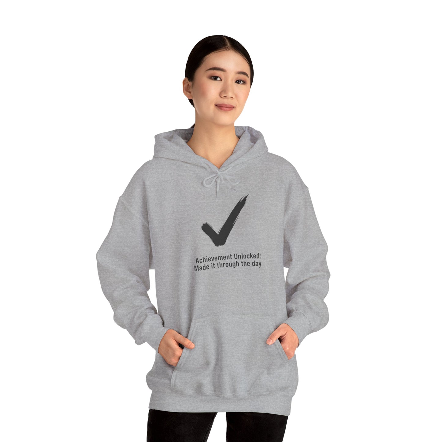 Person wearing a gray hoodie with a checkmark design and text 'Achievement Unlocked: Made it through the day' on a white background