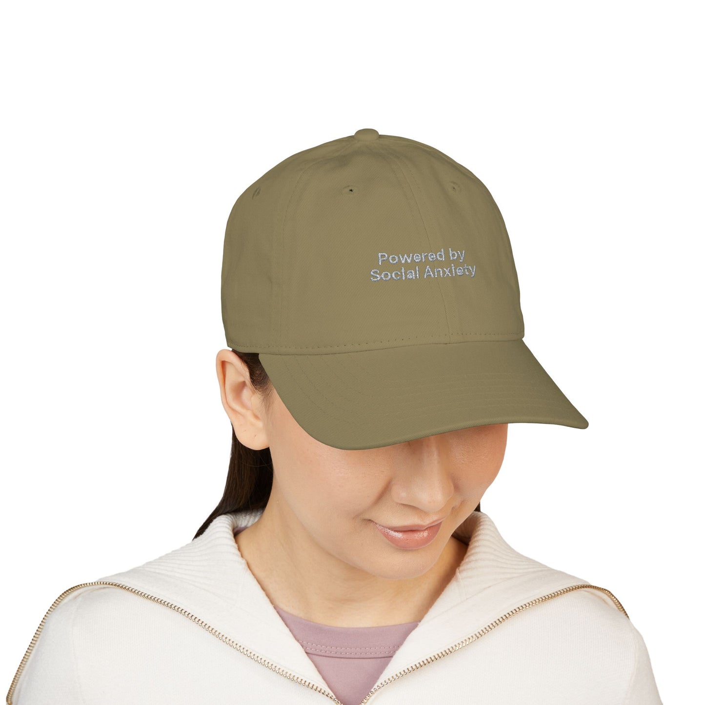 Person wearing a green cap with 'Powered by Social Anxiety' text on a white background