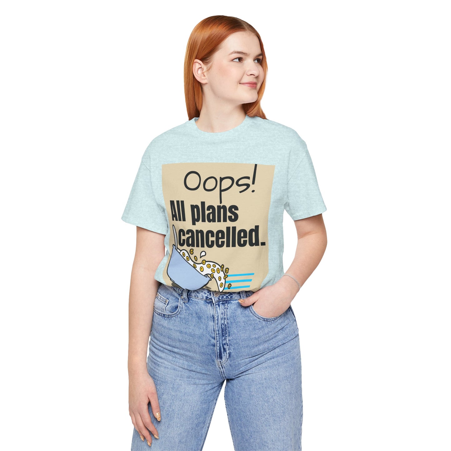 Person wearing a light blue t-shirt with a graphic and text 'Oops! All plans cancelled.'