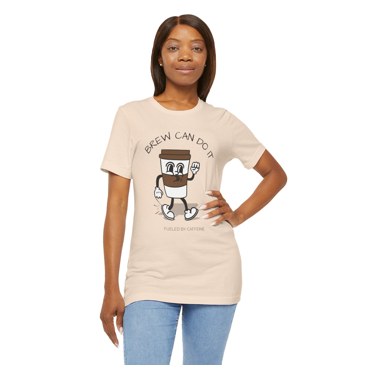 Woman wearing a beige t-shirt with a coffee-themed graphic and text 'Brew Can Do It Fueled By Caffeine'.
