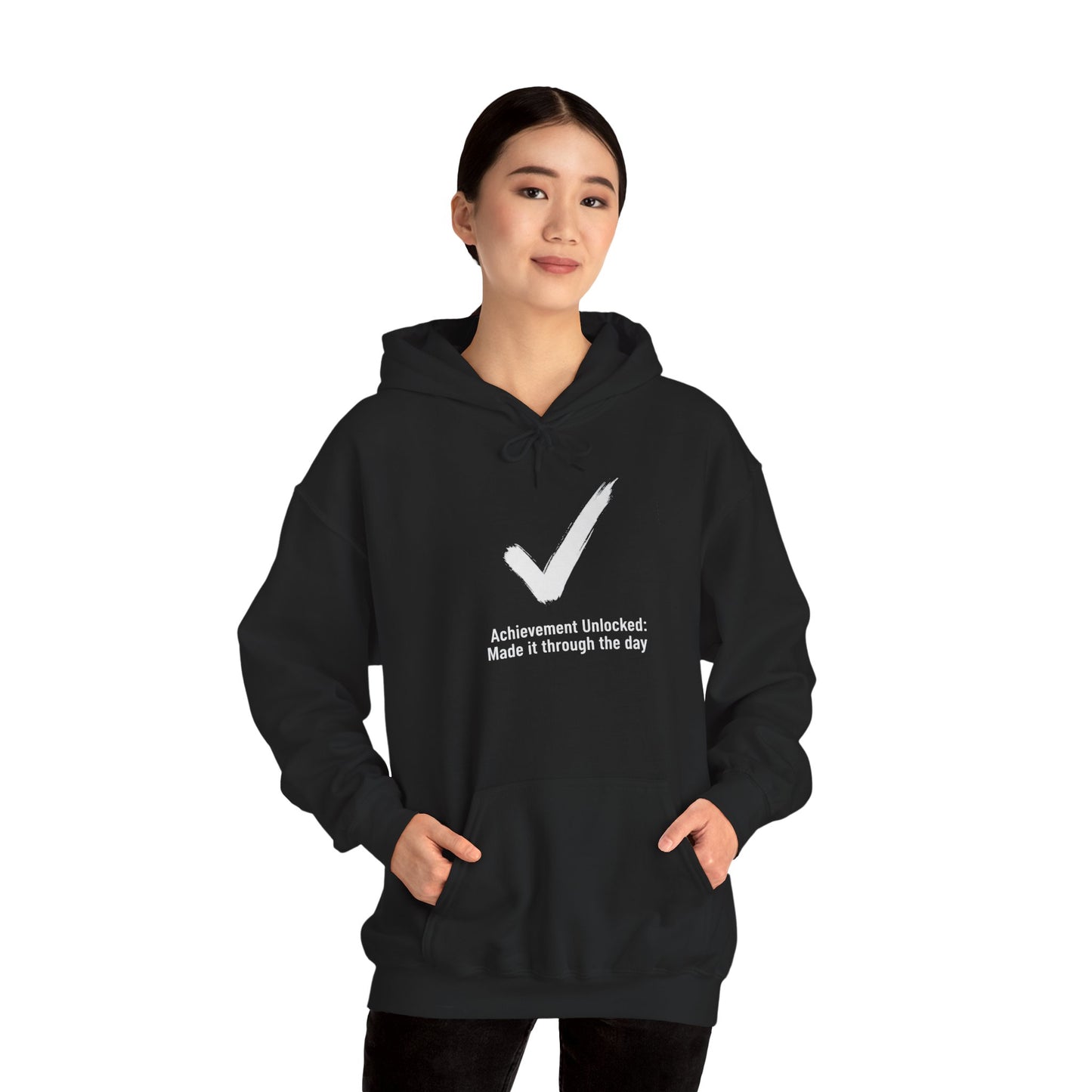 Person wearing a black hoodie with a white checkmark and text 'Achievement Unlocked: Made it through the day' on a white background