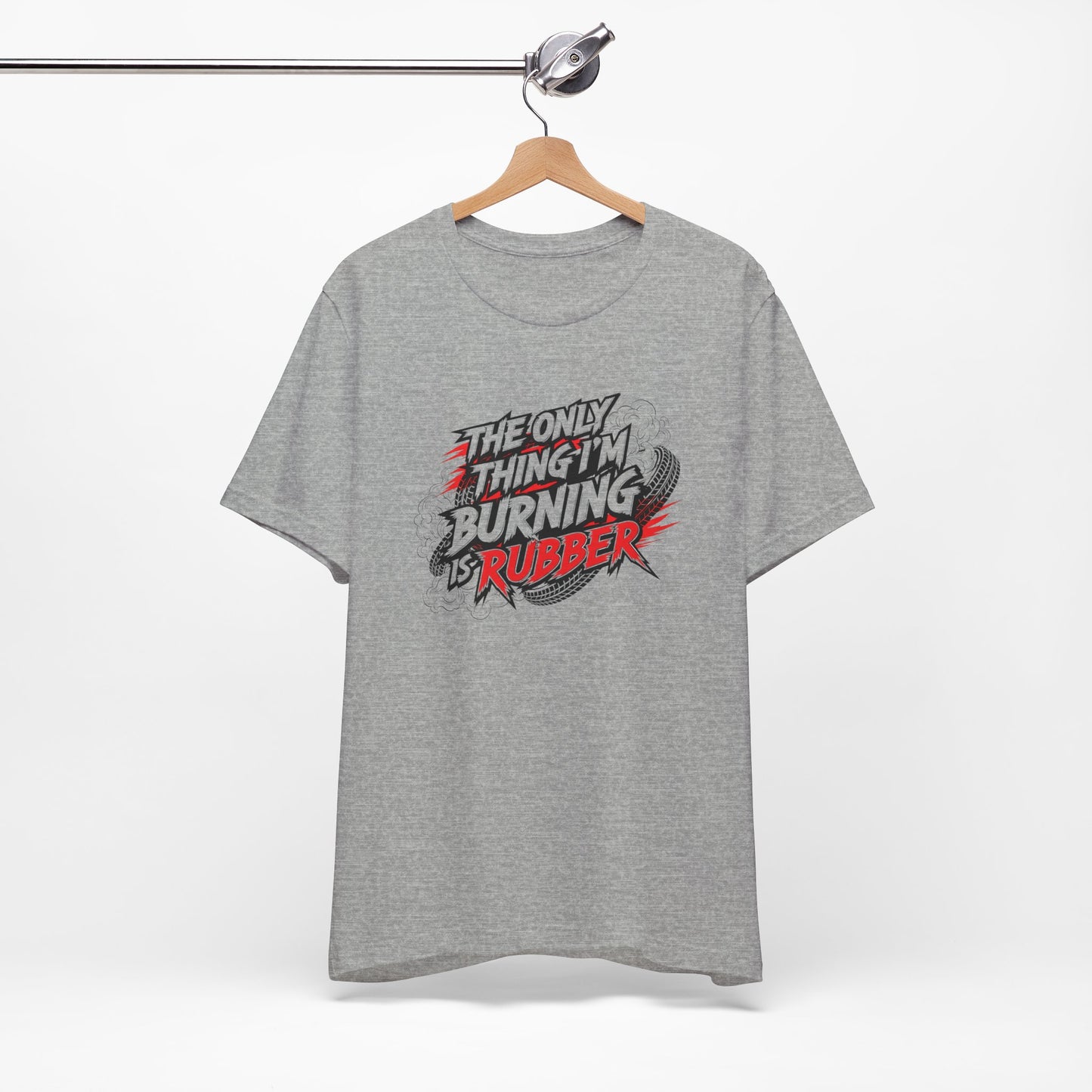 Gray t-shirt with a graphic design and text 'The only thing I'm burning is rubber' on a hanger against a white background