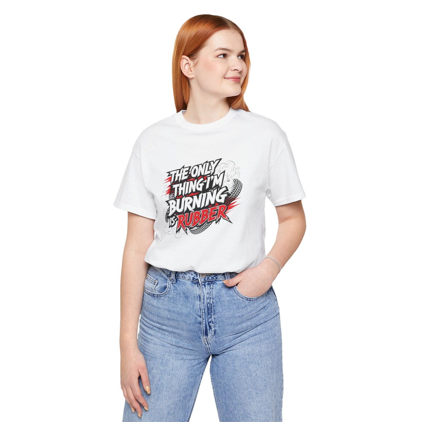 Person wearing a white t-shirt with a graphic design and text 'The only thing I'm burning is rubber', standing against a white background