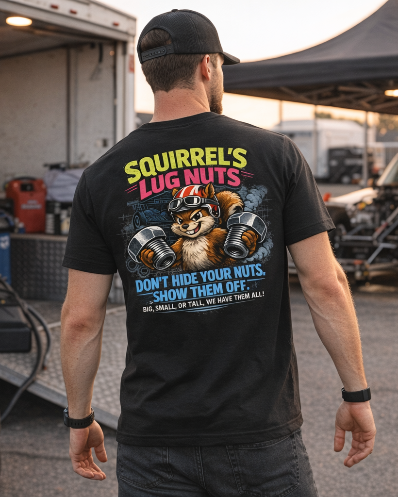 Man wearing a black t-shirt with a graphic design and 'Squirrel's Lug Nuts' text, standing in a drag race pit crew area.