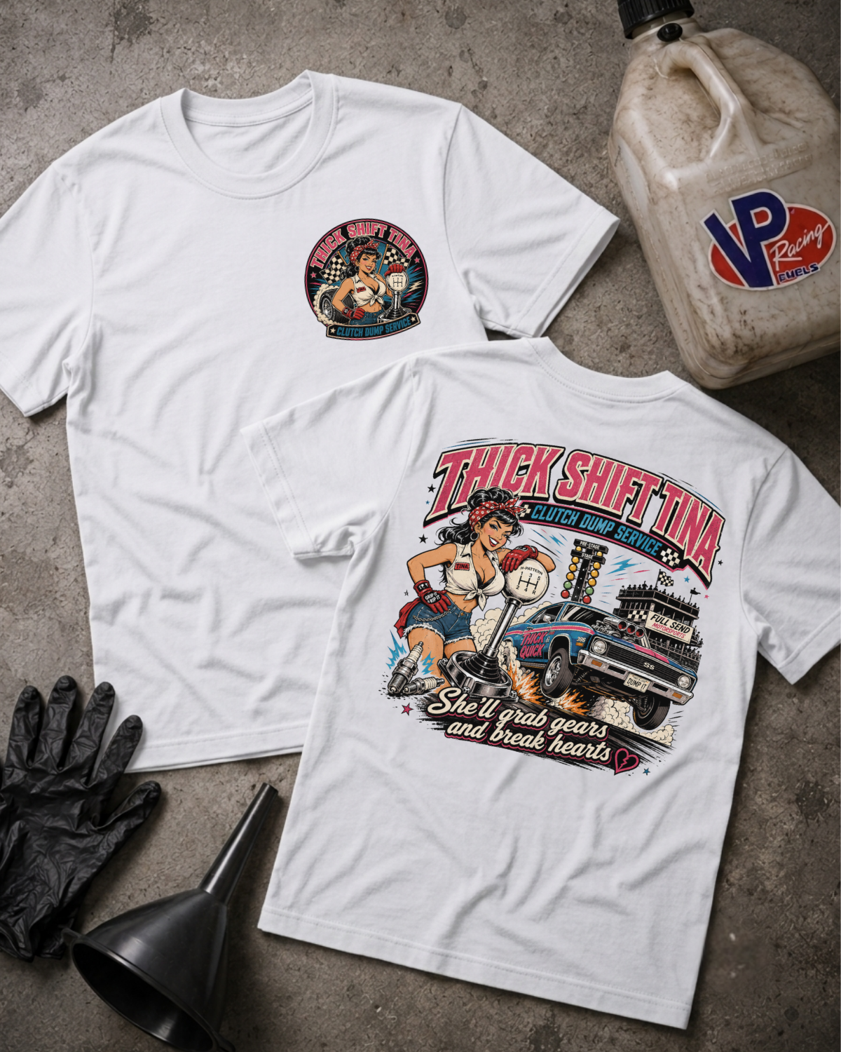 Two white graphic T-shirts laid flat on a gray concrete-style surface, with a black funnel, black gloves, and a VP Racing jug as props. The front shirt has a small circular chest graphic, and the back shirt has a large colorful racing-style graphic with the text 'THICK SHIFT TINA CLUTCH DUMP SERVICE' and 'She'll grab gears and break hearts.
