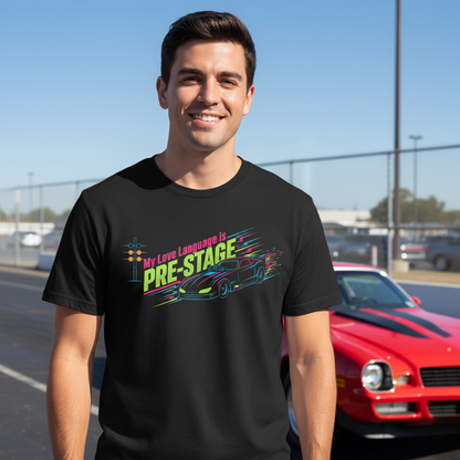 Man wearing a black t-shirt with colorful graphic and 'My Love Language is Pre-Stage' text, standing in front of a red car.