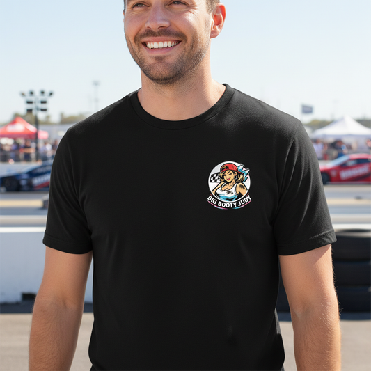 Man wearing a black t-shirt with a logo and 'Big Booty Judy' text, standing outdoors.