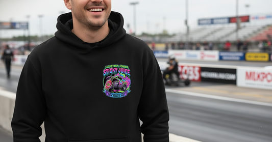 Person wearing a black hoodie with a colorful graphic 'Jackstand Jemima' logo on a race track background