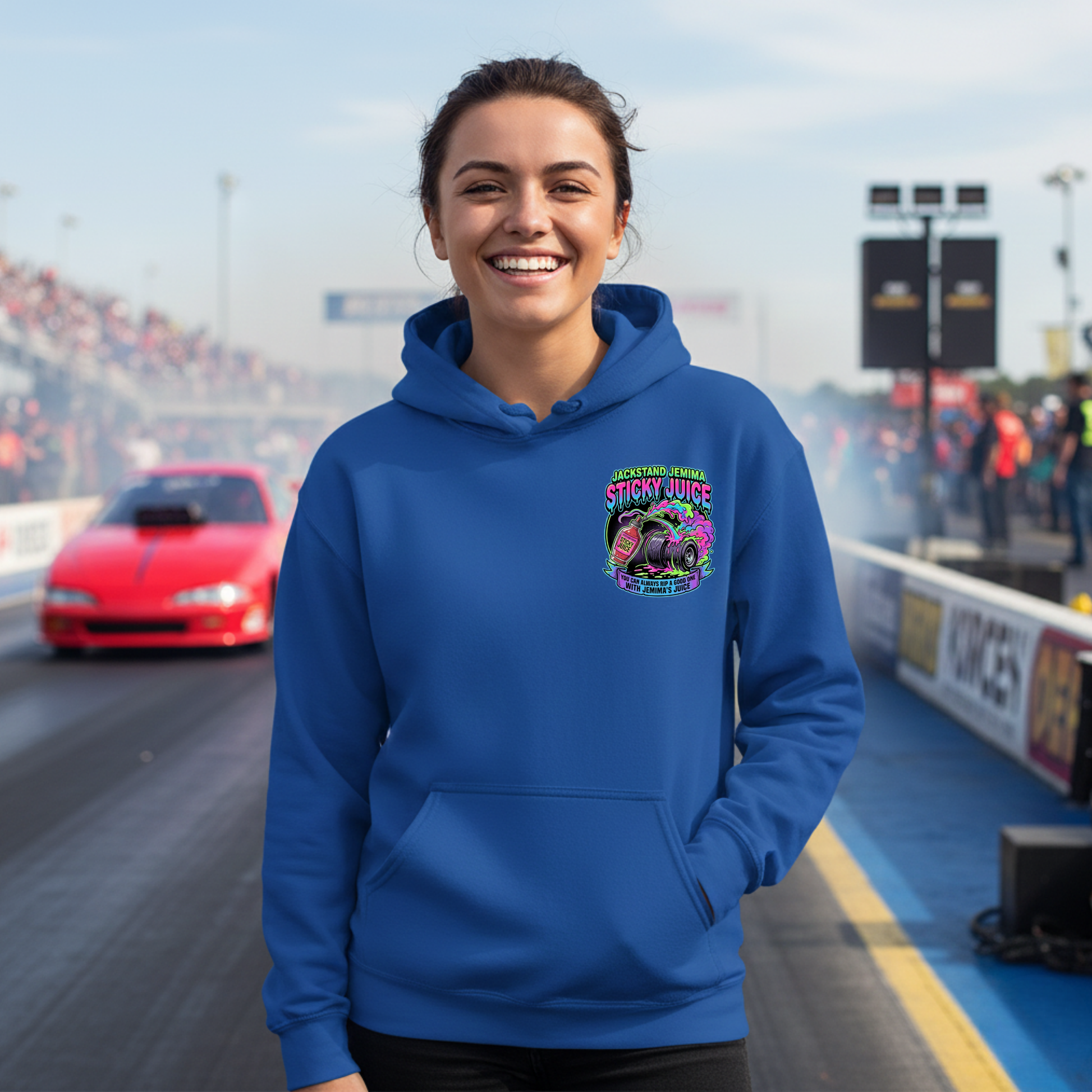 Person wearing a blue hoodie with a colorful graphic 'Jackstand Jemima' logo on a race track background