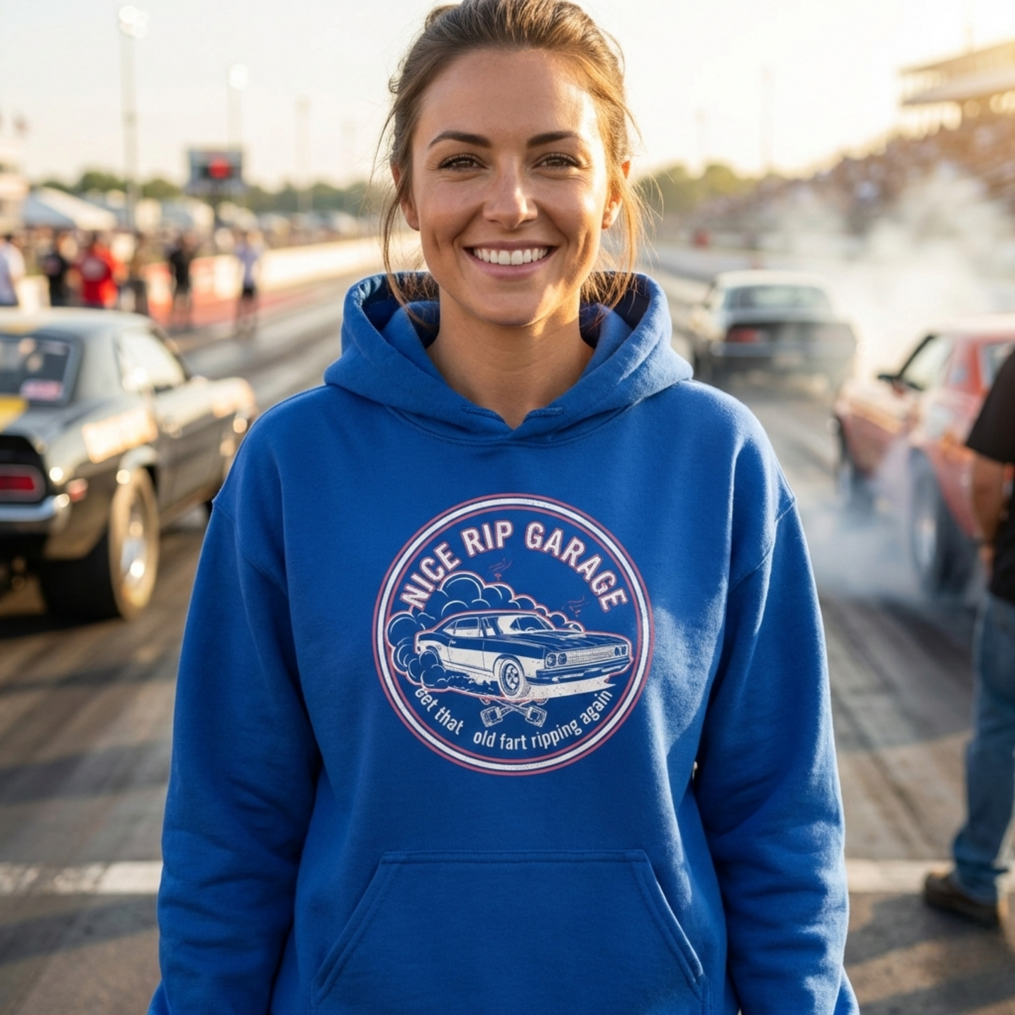 Person wearing a blue hoodie with 'Nice Rip Garage' logo at a car event.
