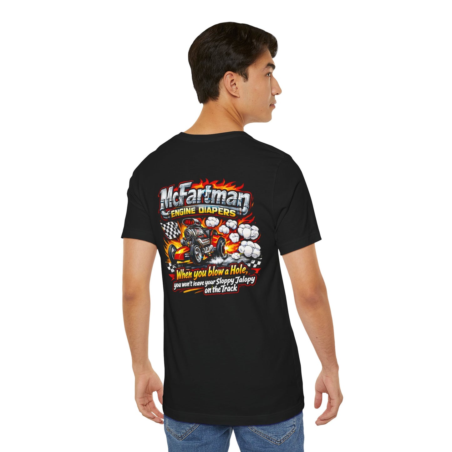 Person wearing a black t-shirt with colorful graphics and 'McFartman Engine Diapers When you blow a Hole, you won't leave your Sloppy Jalopy on the Track' text on the back
