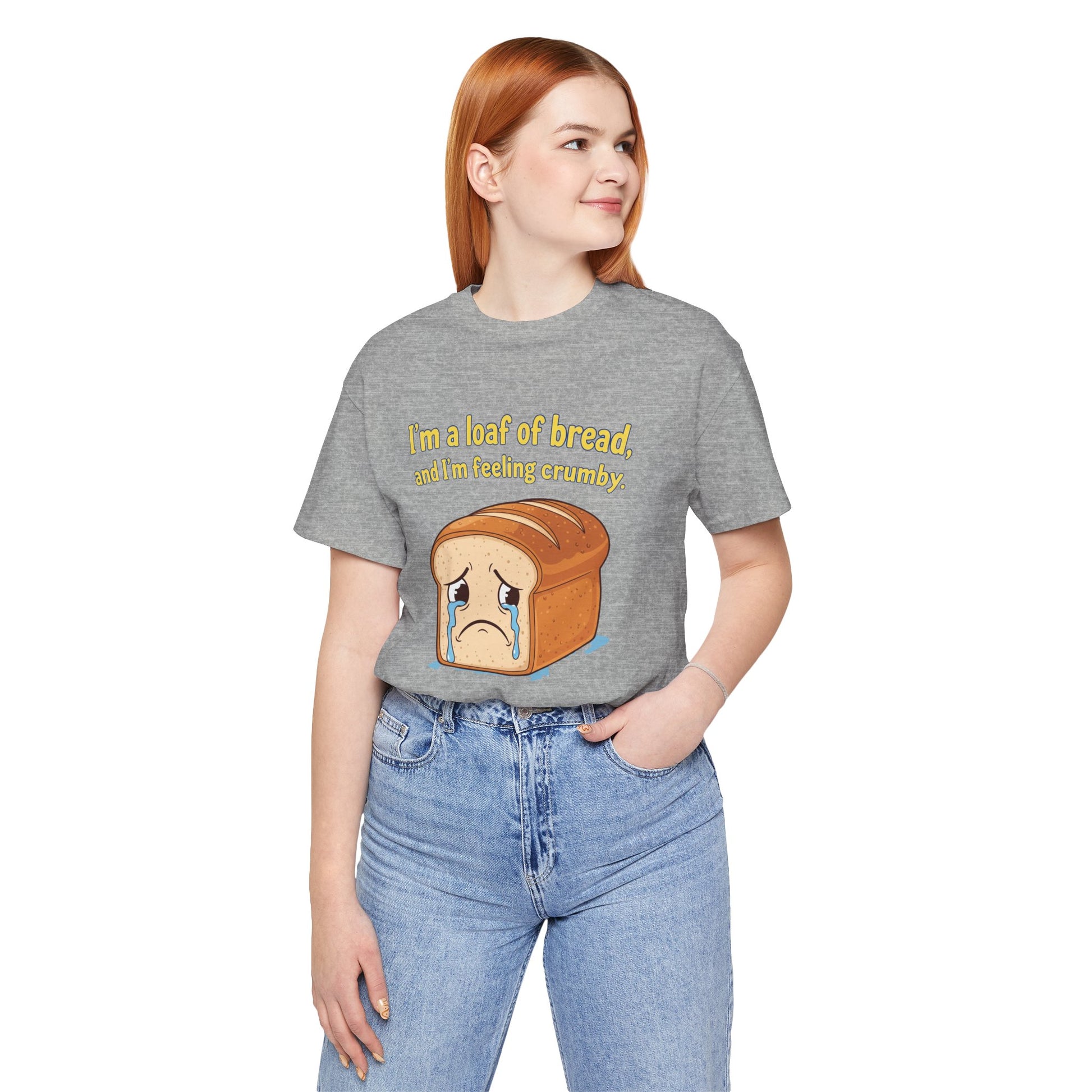 Person wearing a gray t-shirt with a bread graphic and text on a white background. Text says, 'I'm a loaf of bread, and I'm feeling crumby'