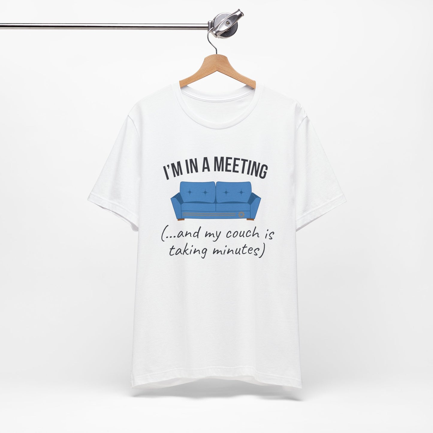 White t-shirt with a graphic of a blue couch and text 'I'm in a meeting (...and my couch is taking minutes)'on a white background