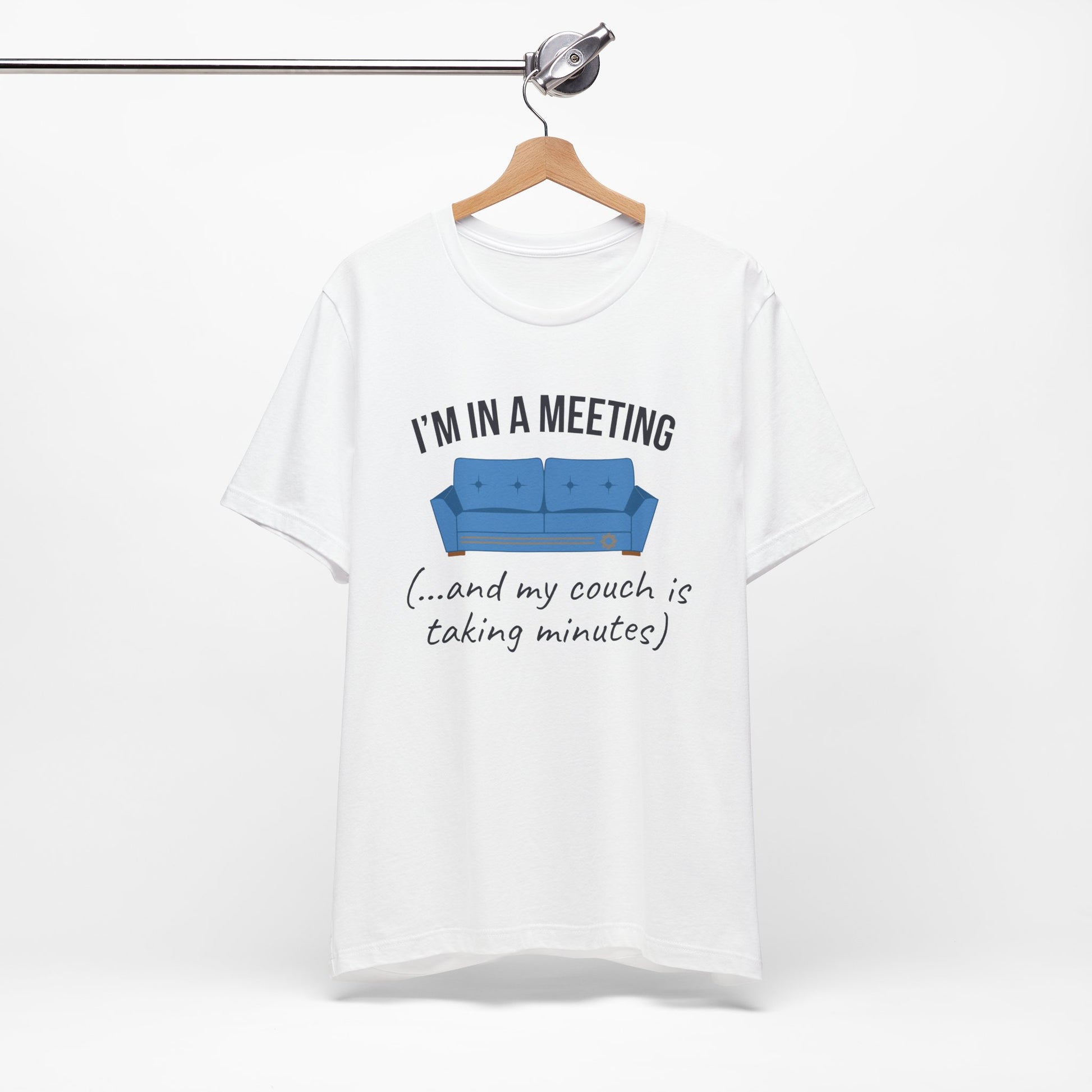 White t-shirt with a graphic of a blue couch and text 'I'm in a meeting (...and my couch is taking minutes)'on a white background