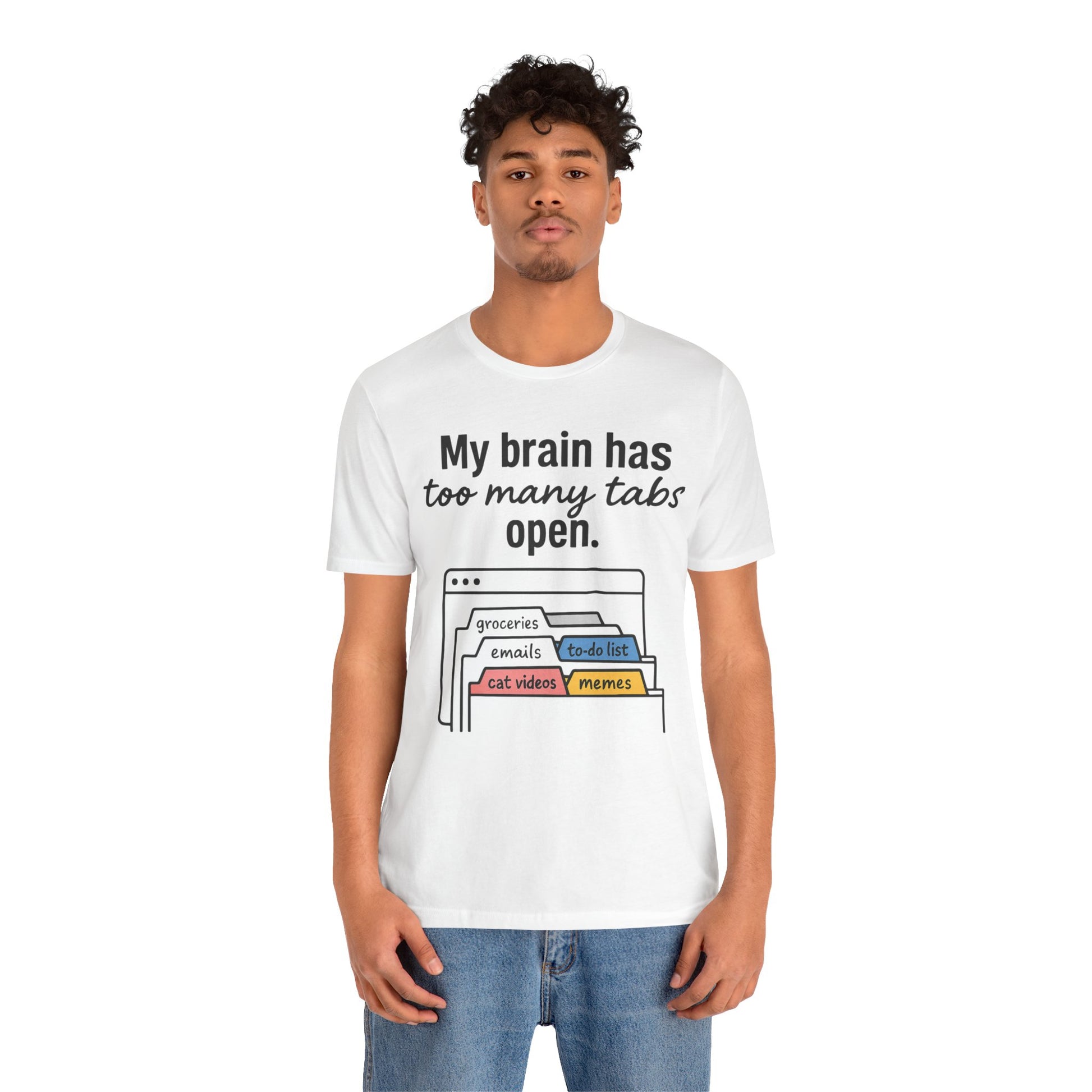 Person wearing a white t-shirt with text 'My brain has too many tabs open' and graphics on a white background
