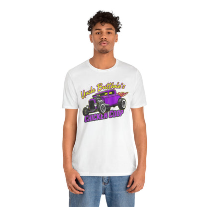 Person wearing a white t-shirt with a graphic design and text 'Uncle Butthole's Chicken Coop' on a white background