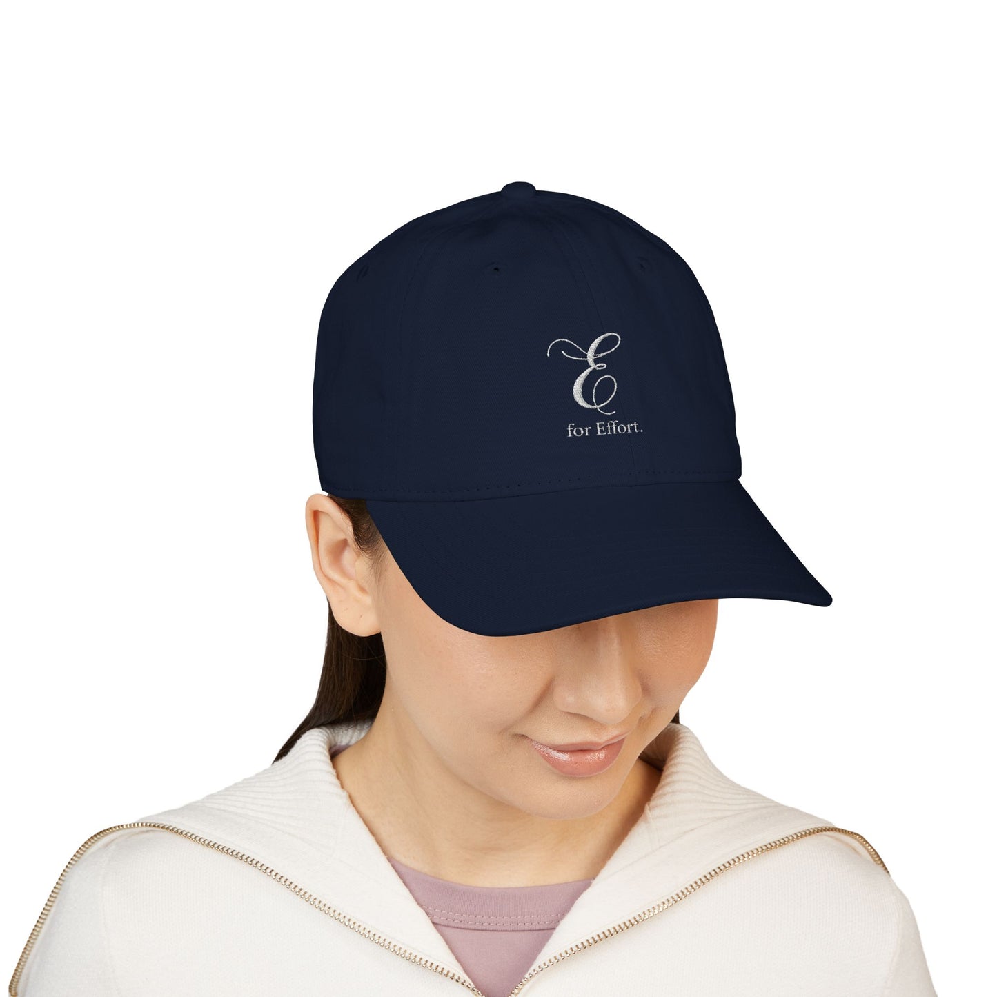 Navy cap with 'E for Effort' logo worn by a person on a white background