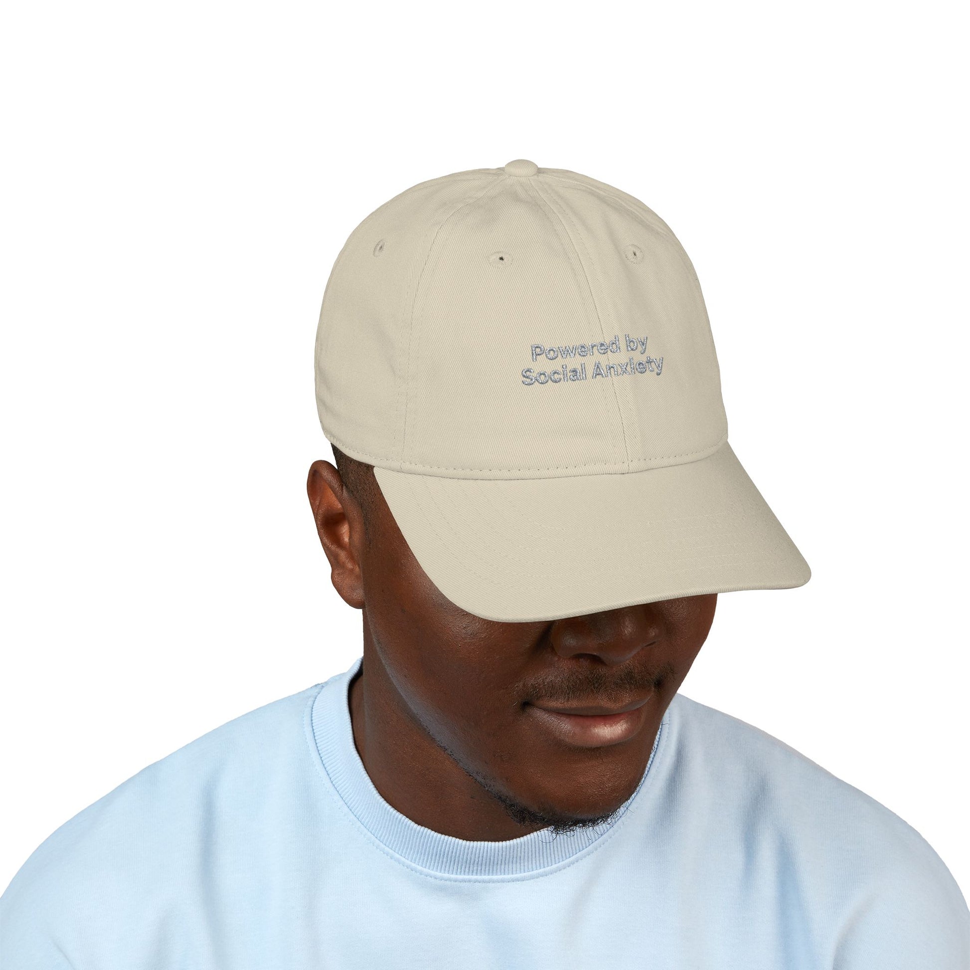 Man wearing a beige cap with text on a white background