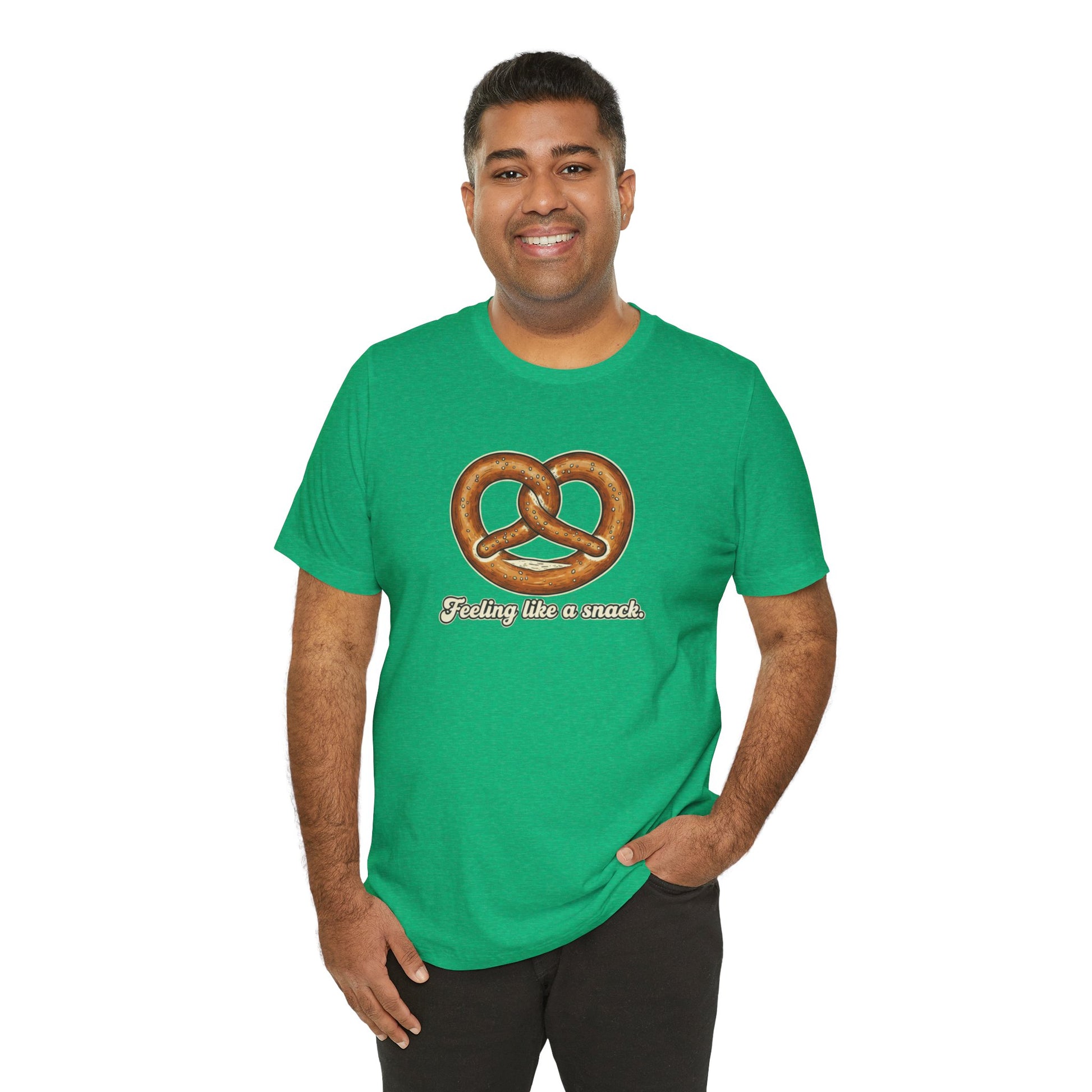 Man wearing a green t-shirt with a pretzel graphic and text 'Feeling like a snack' on a white background