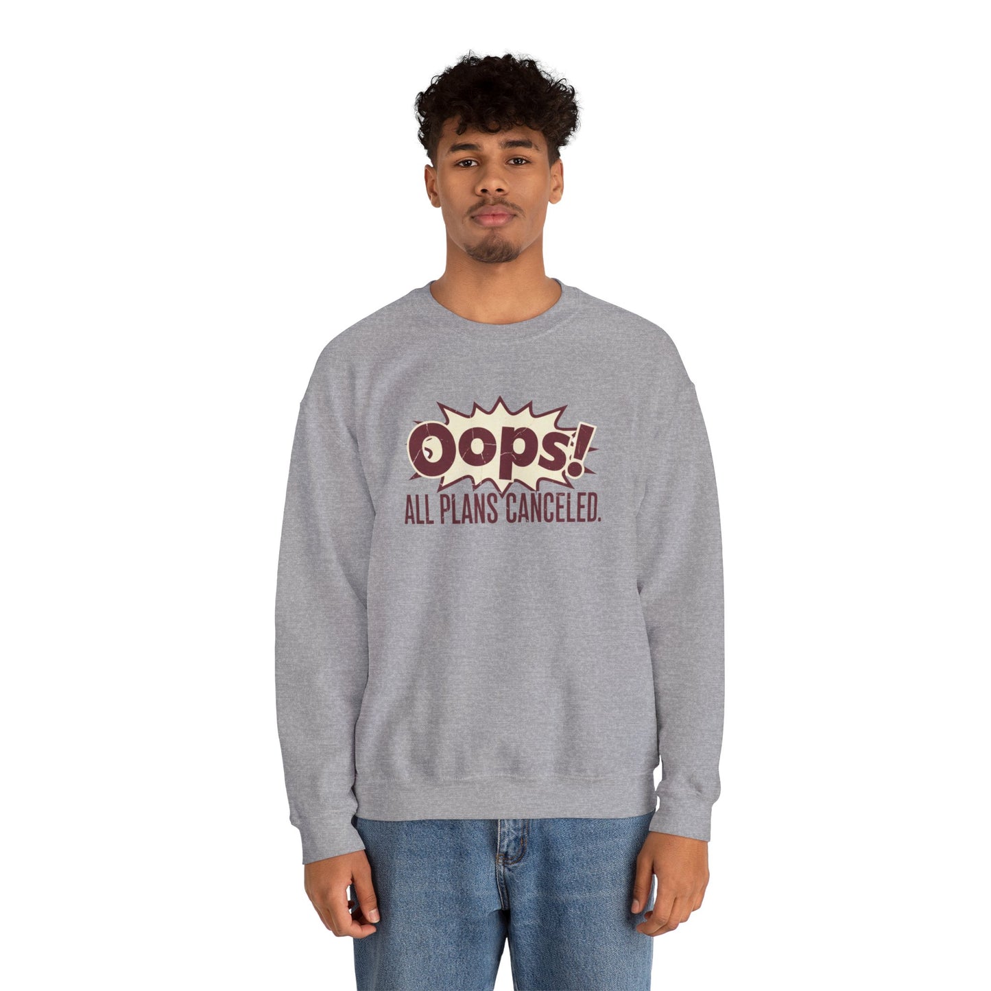 Person wearing a gray sweatshirt with 'Oops! All Plans Canceled' text on a white background