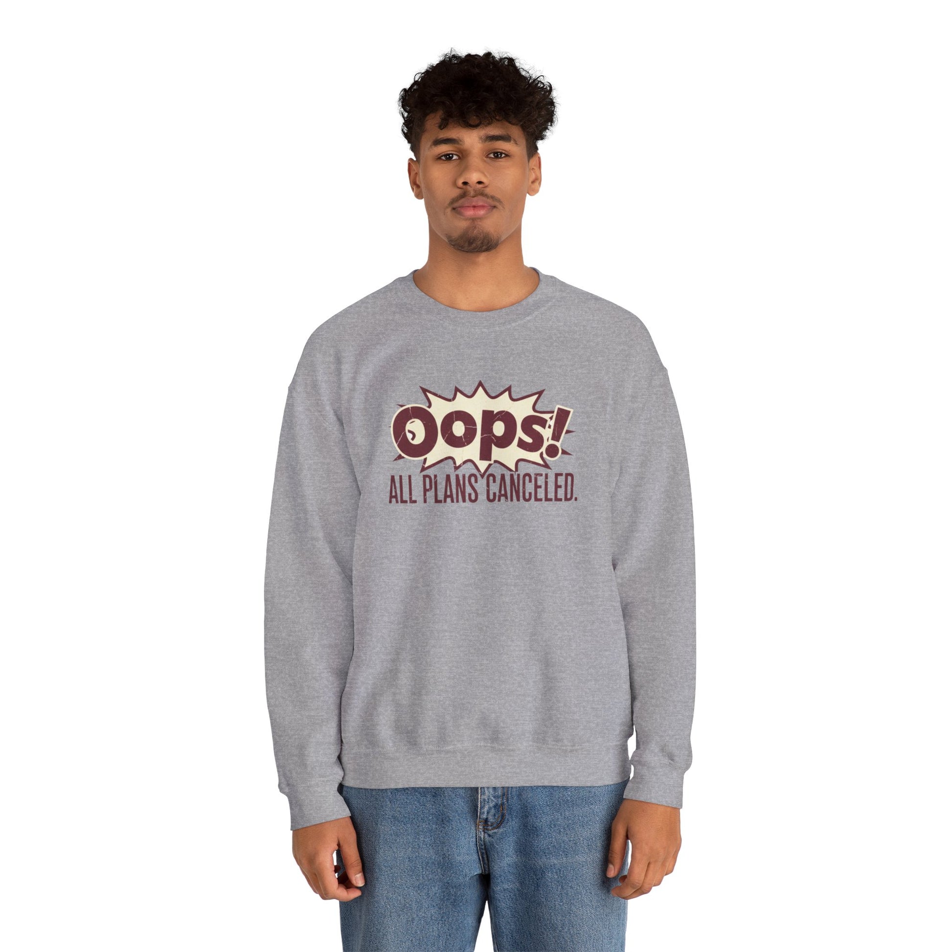 Person wearing a gray sweatshirt with 'Oops! All Plans Canceled' text on a white background