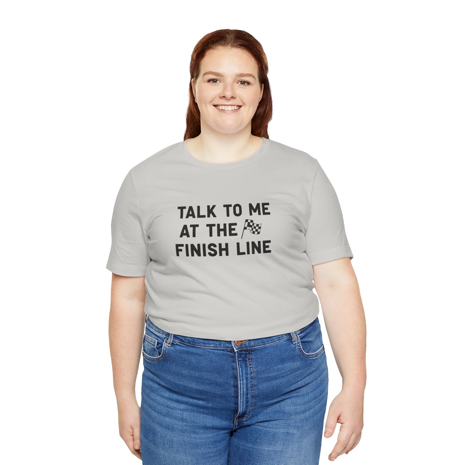 Person wearing a gray t-shirt with 'Talk to me at the finish line' text on a white background