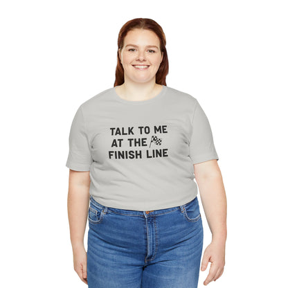 Person wearing a gray t-shirt with 'Talk to me at the finish line' text on a white background