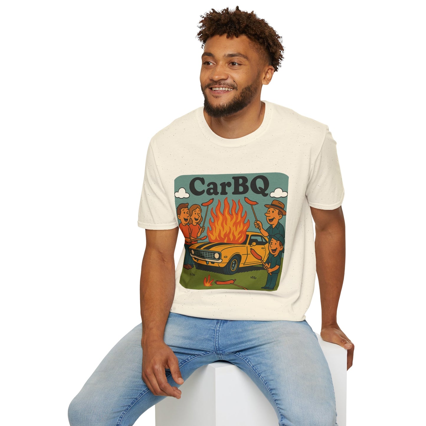 Man wearing a t-shirt with a graphic design of a car and people around a fire and text 'CarBQ', sitting on a white stool.