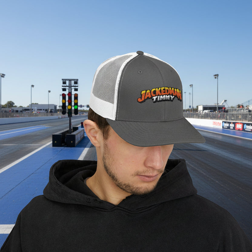 Man wearing a gray and white cap with 'Jacked Up Timmy' text on a drag strip