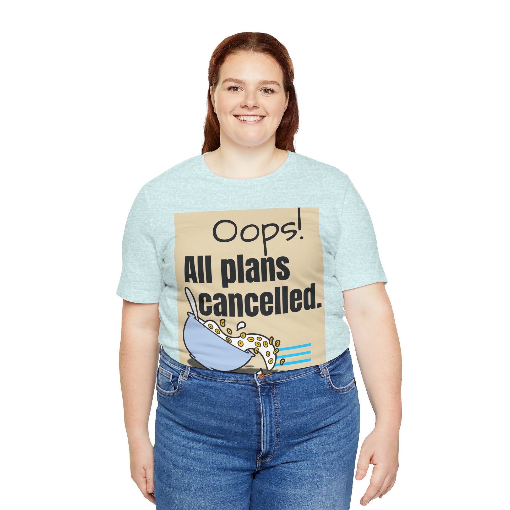 Person wearing a light blue t-shirt with a graphic and text 'Oops! All plans cancelled.'