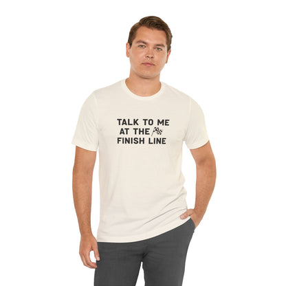Man wearing a white t-shirt with text 'Talk to me at the finish line' on a white background