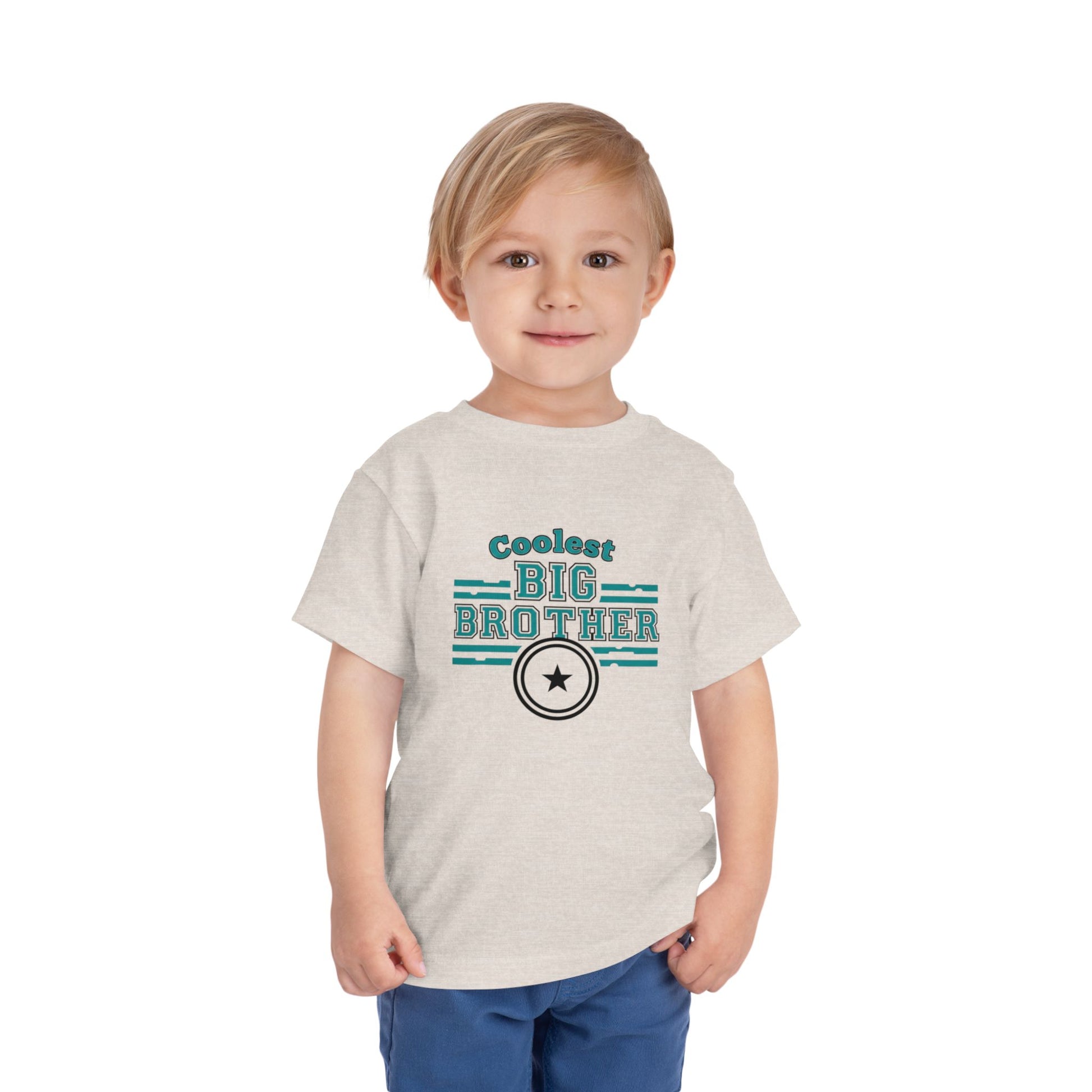Child wearing a 'Coolest Big Brother' t-shirt on a white background