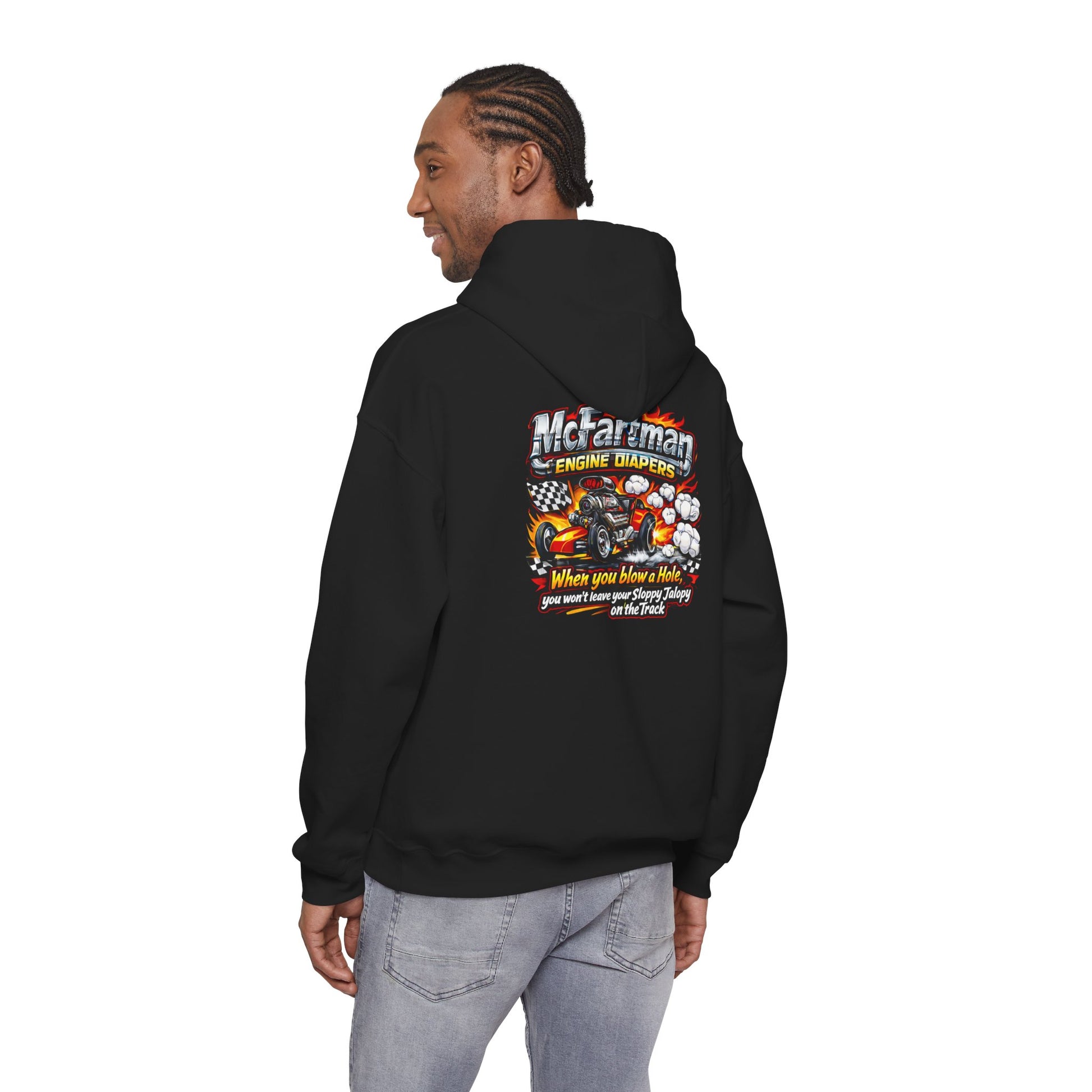 Person wearing a black hoodie with a colorful graphic and  'McFartman Engine Diapers When You Blow a Hole You Won't Leave Your Sloppy Jalopy On The Track' text on the back, standing against a white background.