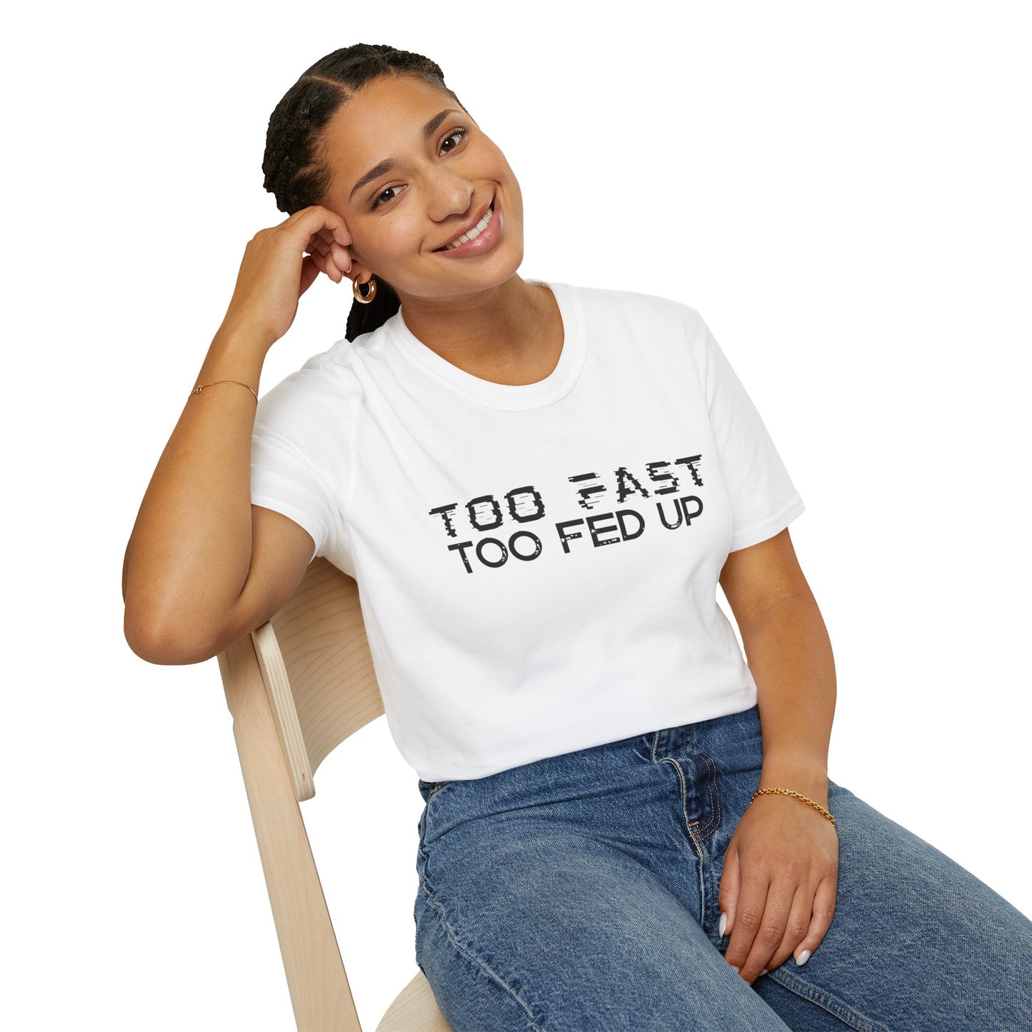 Person wearing a white t-shirt with 'Too Fast Too Fed Up' text, sitting on a chair.