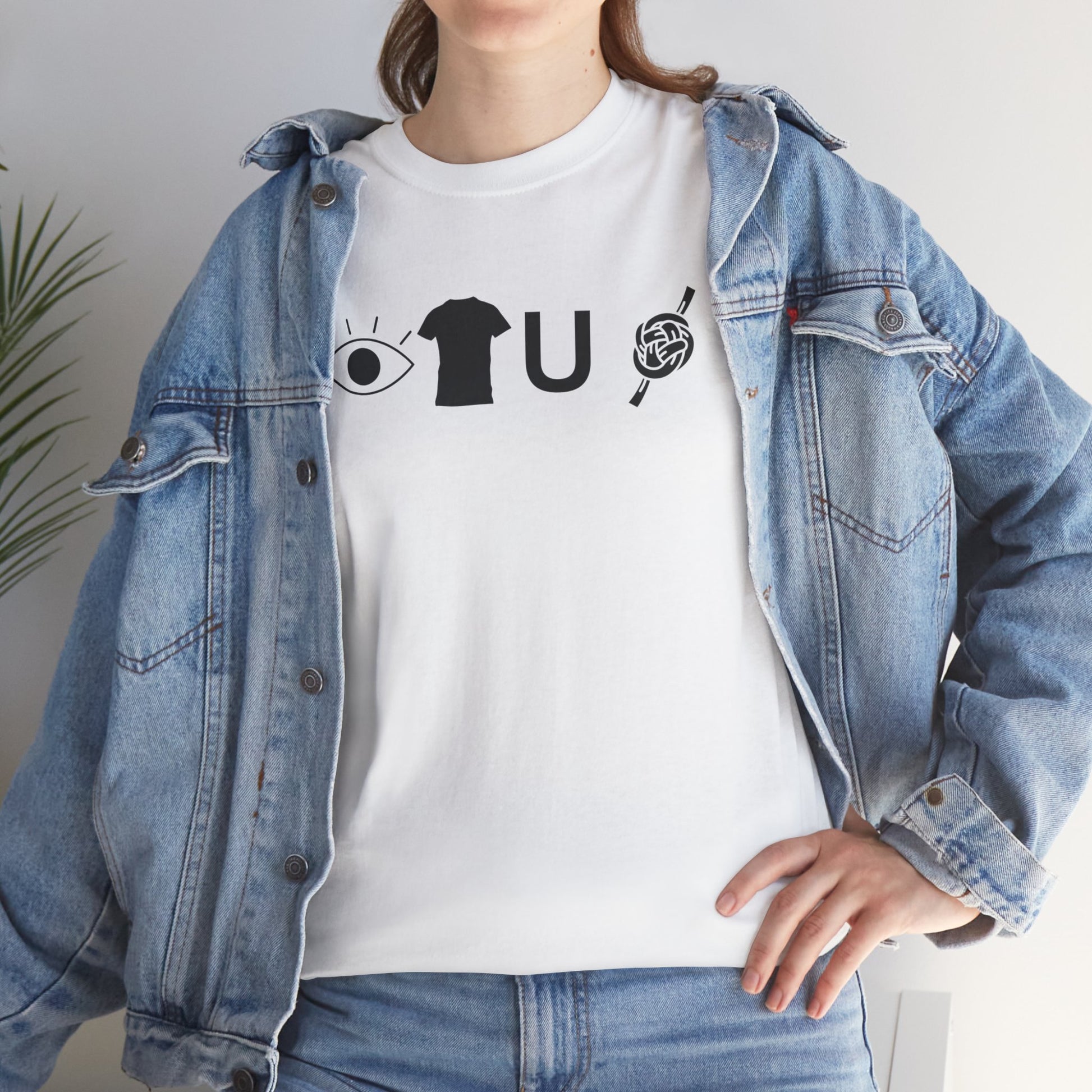 Person wearing a white t-shirt with black graphics and a blue denim jacket.