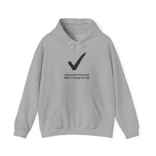 Gray hoodie with a black checkmark and text 'Achievement Unlocked: Made it through the day' on a white background