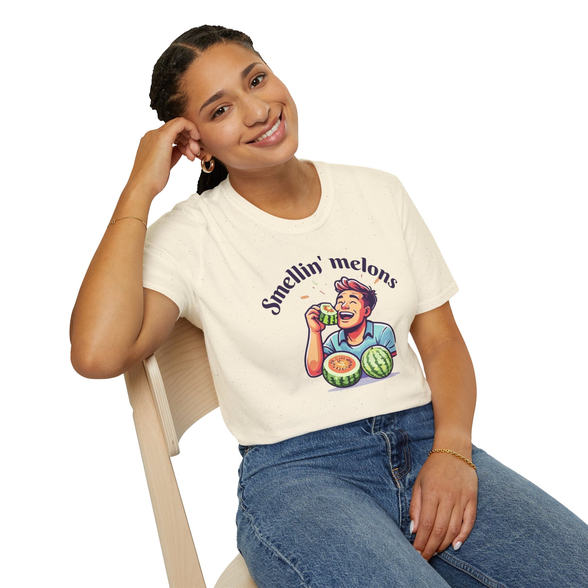 Person wearing a white t-shirt with a graphic and text 'Smellin' melons' design sitting on a chair.