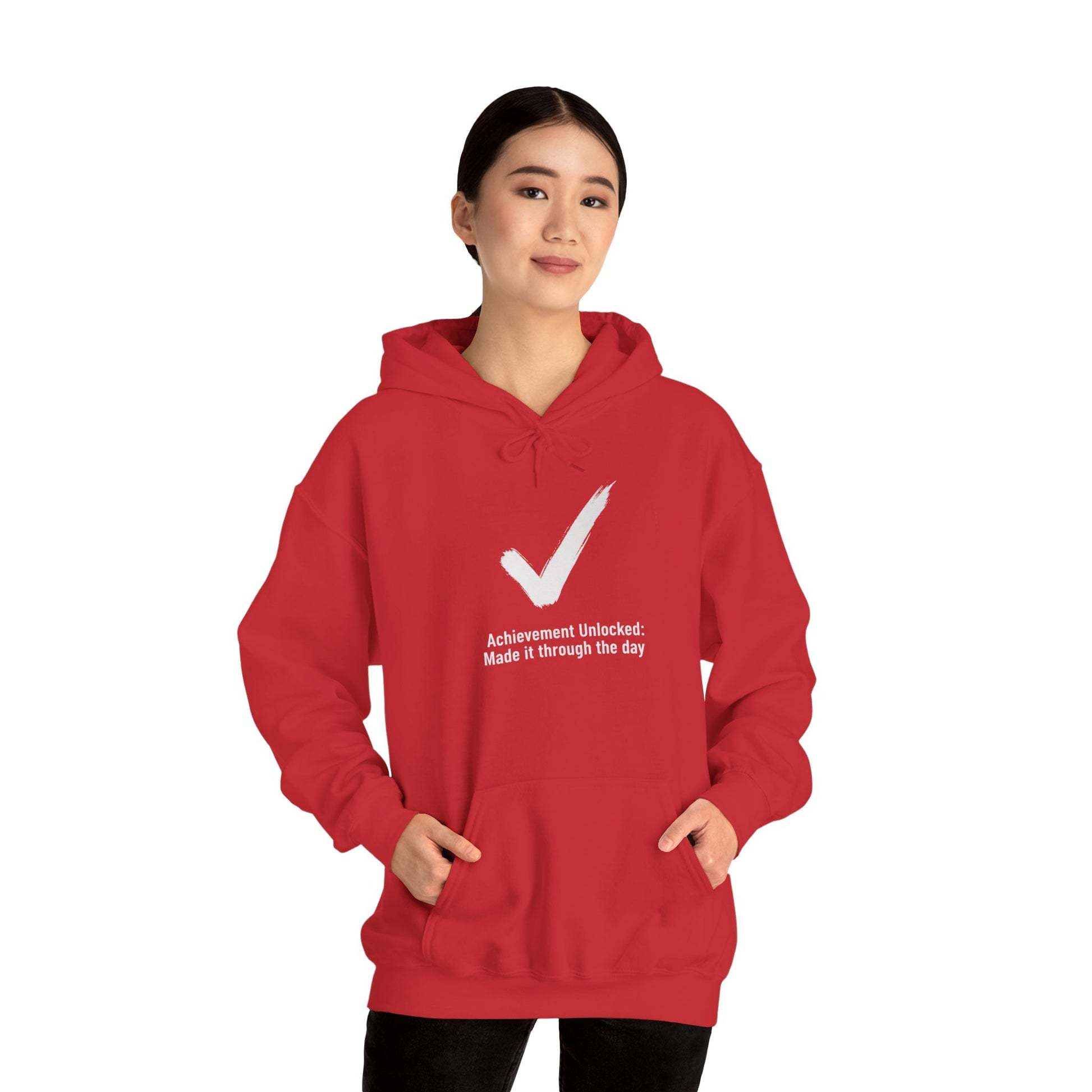 Person wearing a red hoodie with a white checkmark and text 'Achievement Unlocked: Made it through the day' on a white background