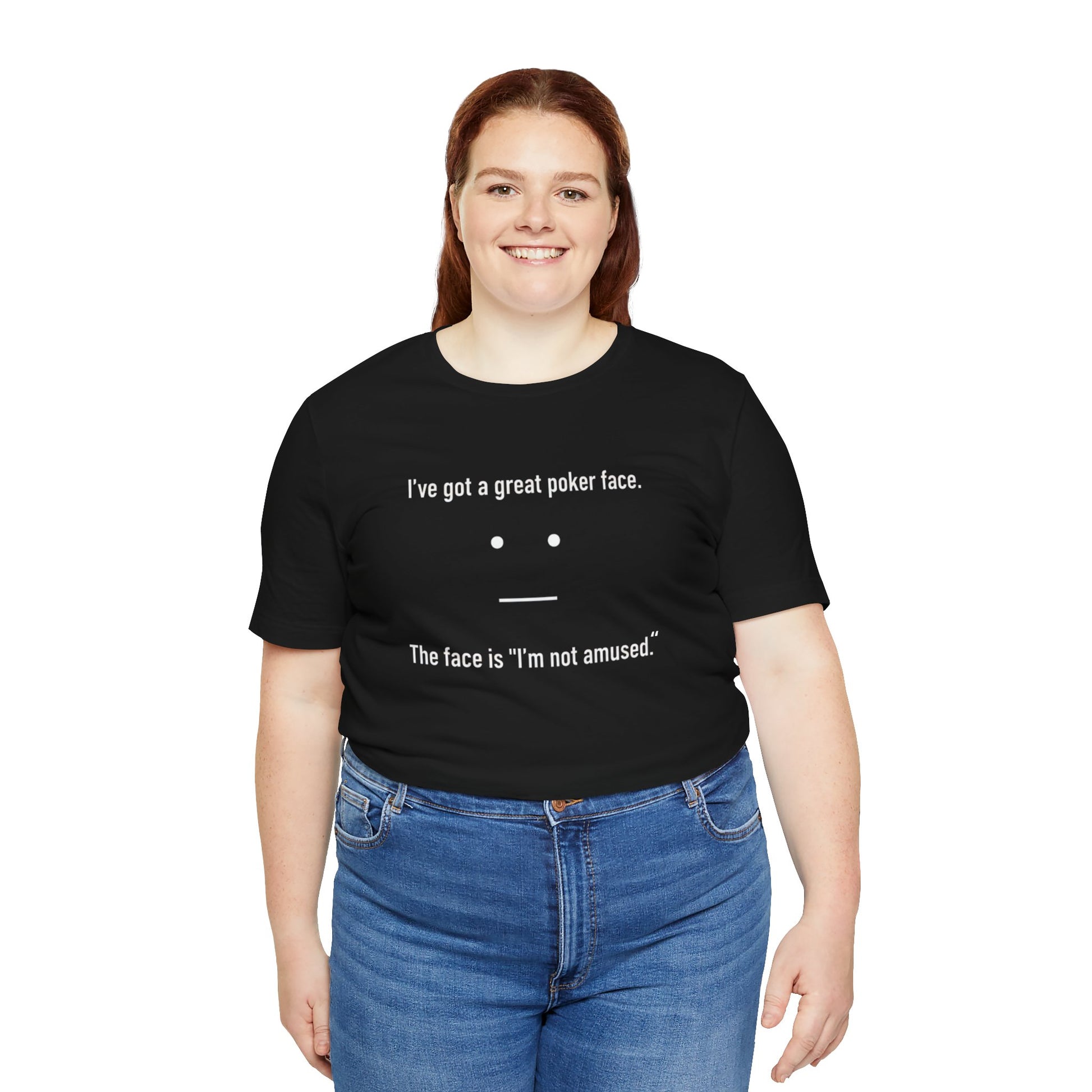 Person wearing a black t-shirt with text 'I've got a great poker face. The face is I'm not amused.' and a face graphic on a white background