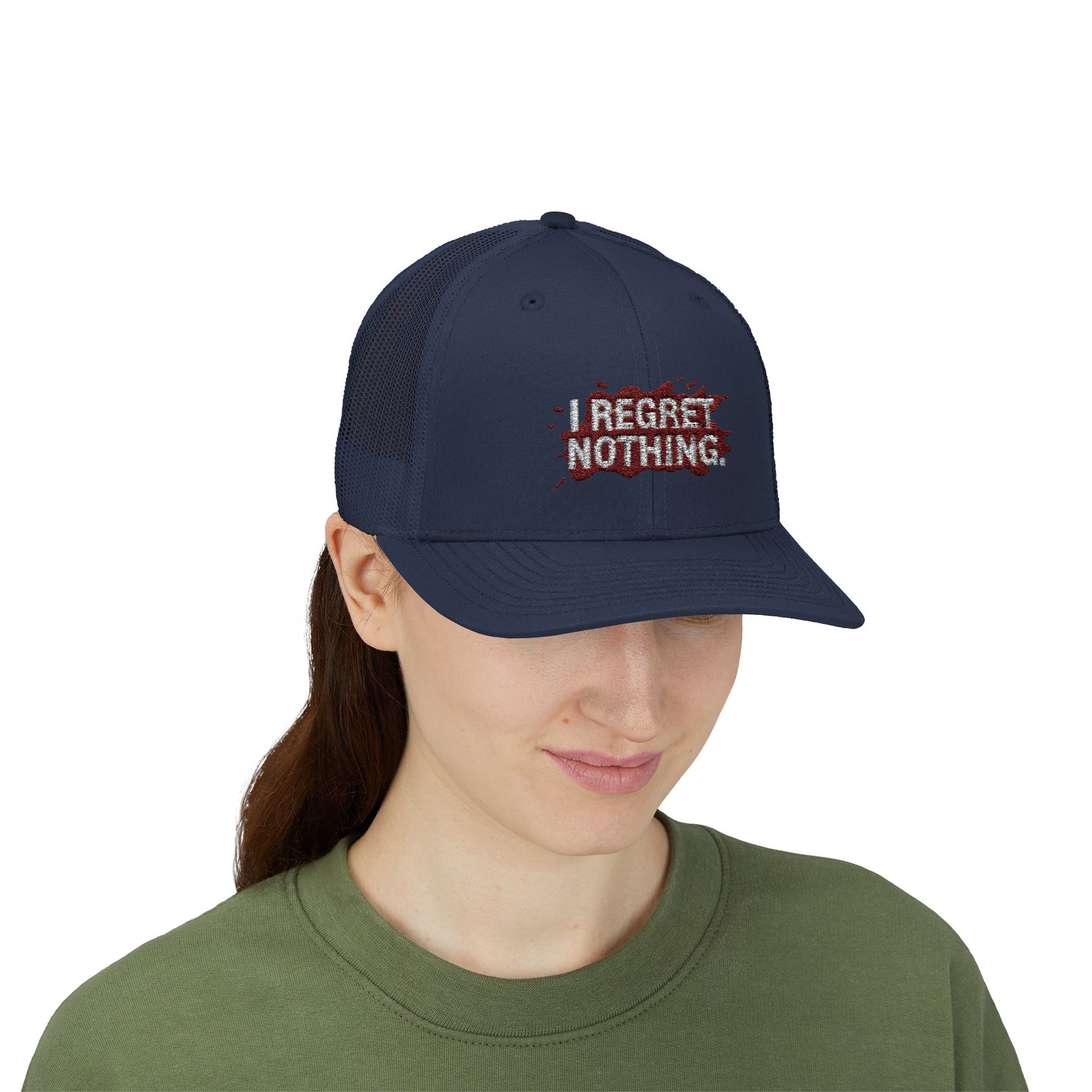 Person wearing a navy blue cap with 'I Regret Nothing' text on a white background