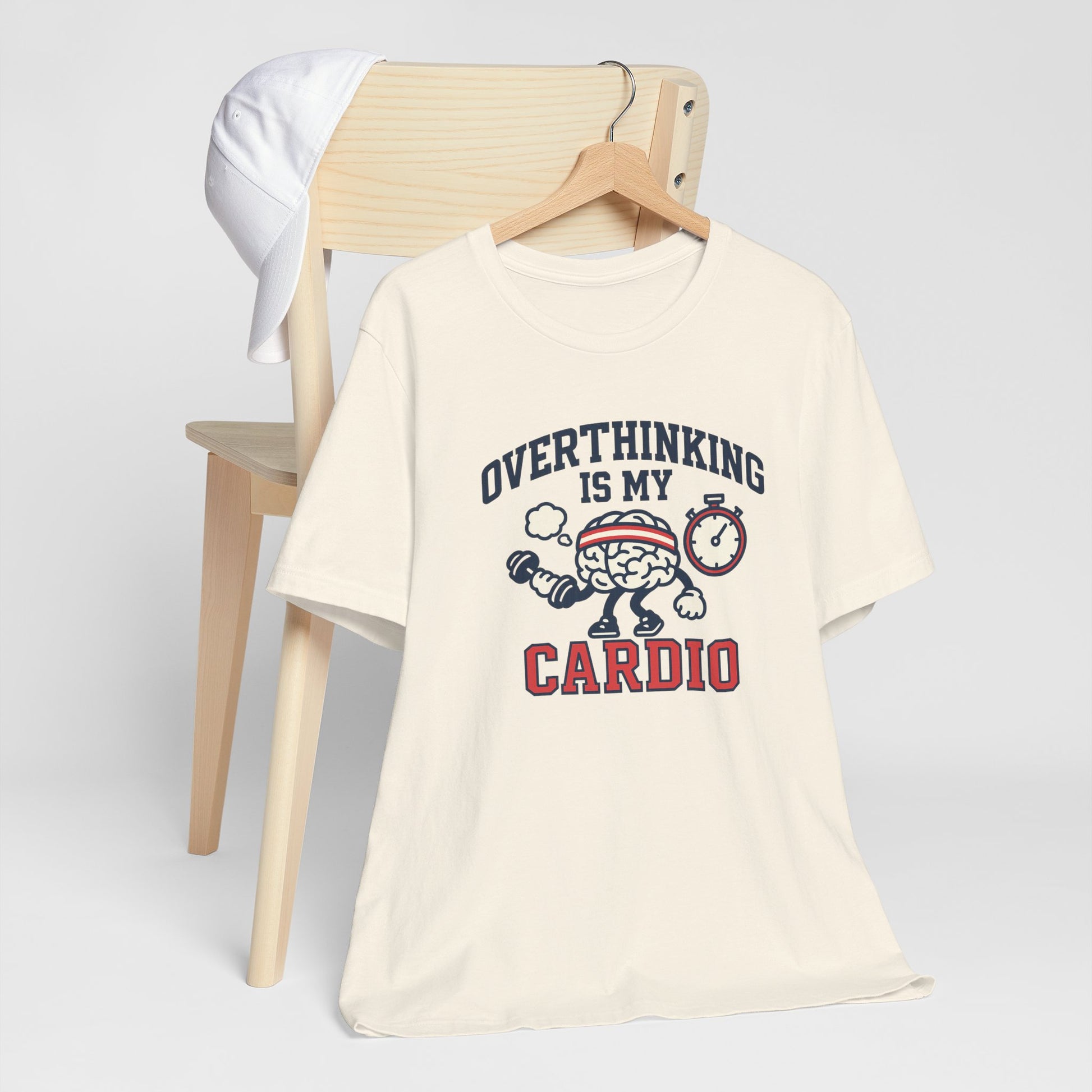 Beige t-shirt with 'Overthinking is my Cardio' graphic design on a chair.