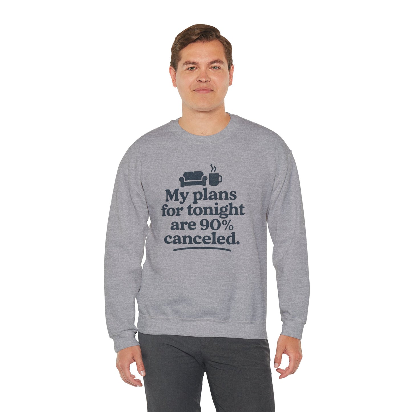 Person wearing a gray sweatshirt with humorous text 'My plans for tonight are 90% canceled' design on a white background