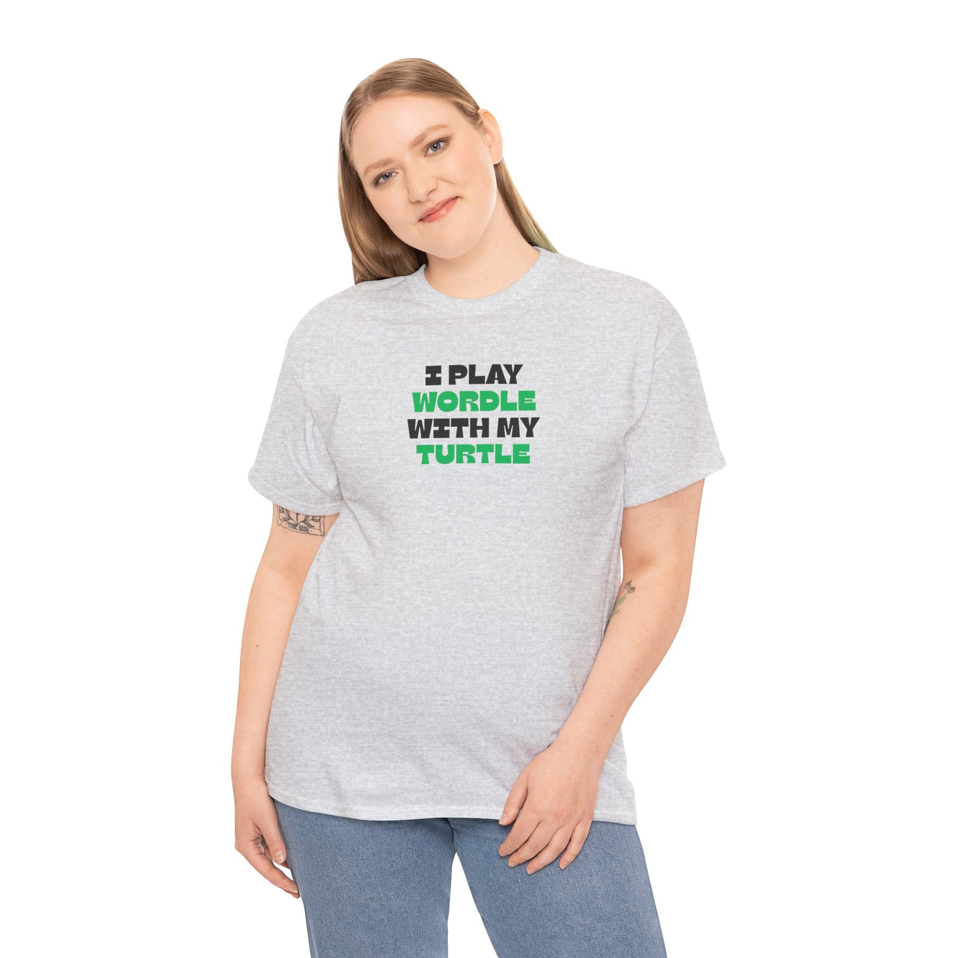 Person wearing a gray t-shirt with green text 'I play wordle with my turtle' on a white background